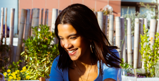 Laughter, woman, table, sharing, plant-based seafood, OLALA!, joyful gathering, companions, meal, dining, hidden faces, happiness, socializing, delicious, sustainable, enjoyment