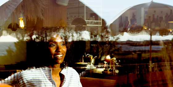 Restaurant, window view, happy diner, enjoyment, ambiance, smile, companions, dining experience, restaurant scene, hidden faces, socializing, pleasant atmosphere